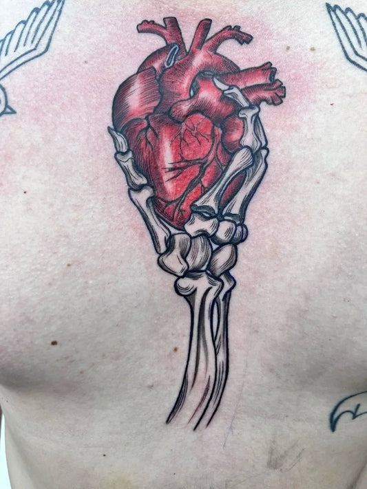Small Illustrative Skeletal Hand Heart Symbol Tattoo on Men Chest
