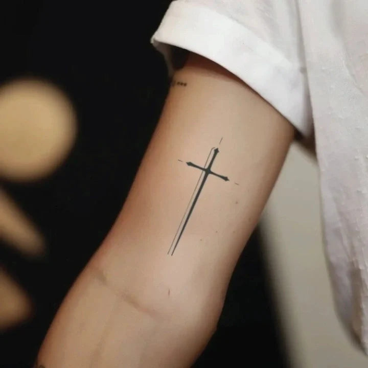 minimal fine line cross bicep temporary tattoo idea design