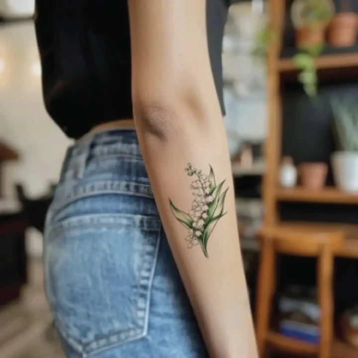 minimalist lily of the valley flower forearm temporary tattoo idea design