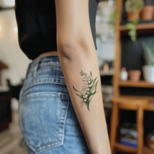minimalist lily of the valley flower forearm temporary tattoo idea design