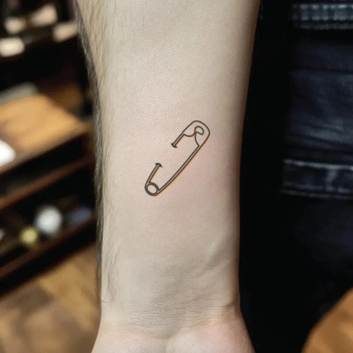 simple safety pin outline forearm temporary tattoo idea design