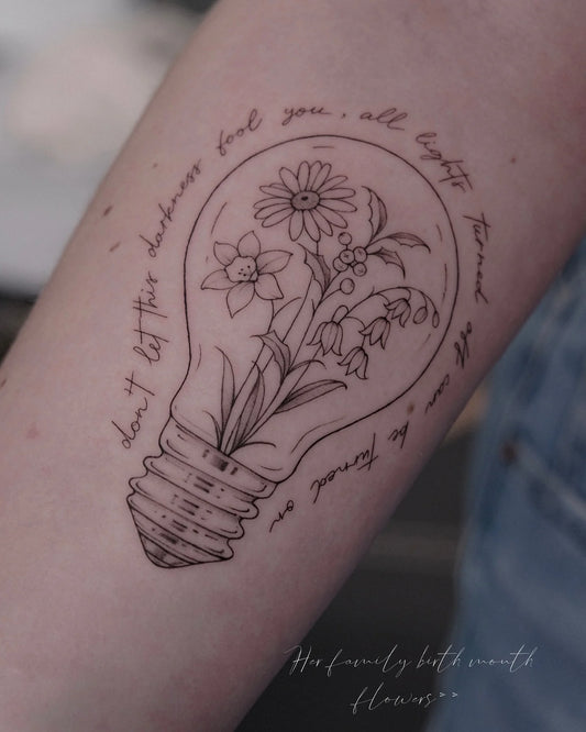 abstract fine line lightbulb tattoo with text and flowers