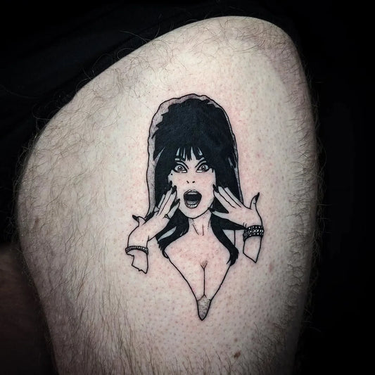 60s 70s long hair woman illustrative tattoo on thigh