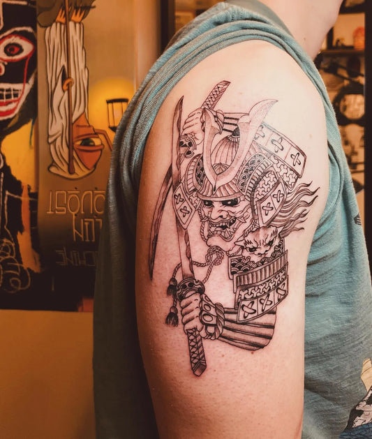 japanese warrior with helmet outline tattoo on man upper arm