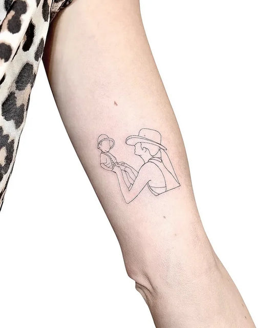 mother and son fine line tattoo outline on woman bicep