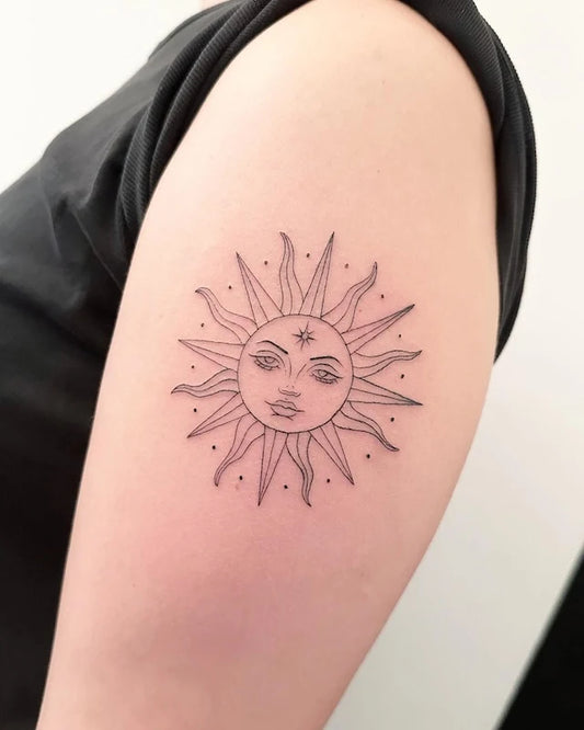 sun with face outline fine line tattoo on upper arm