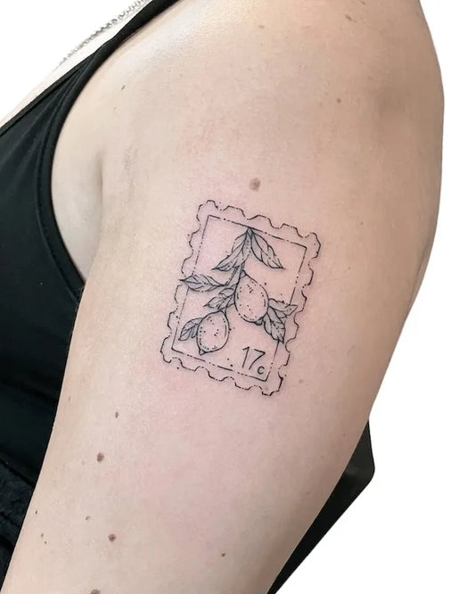 fruit 17c postage stamp outline fine line tattoo on upper arm