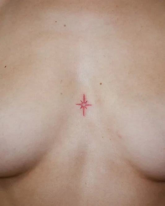 simple small red star outline tattoo on sternum