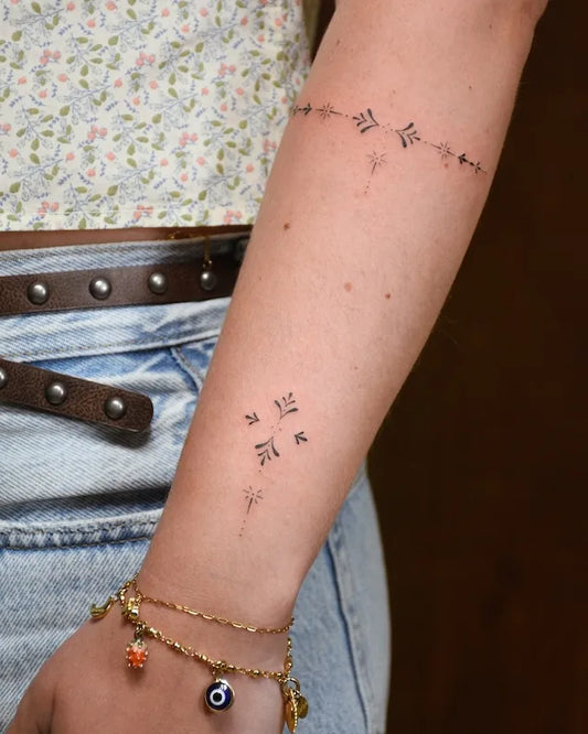 delicate floral ornamental arm wrap tattoo