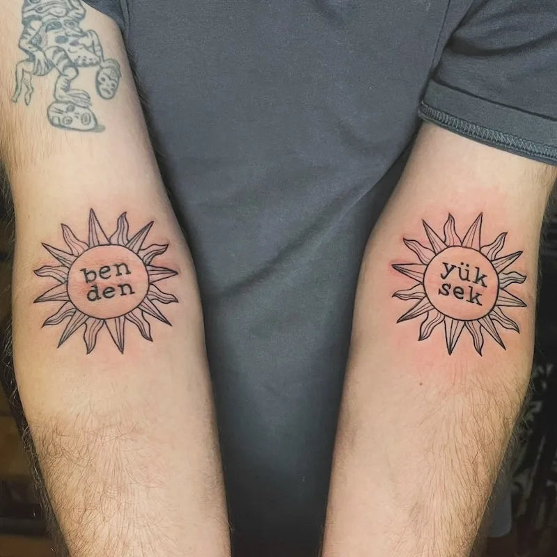matching tribal sun outline with names on arm