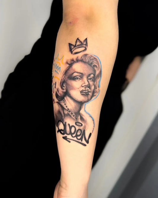 queen woman portrait crown black and grey tattoo on woman forearm