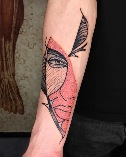 abstract woman half face color tattoo on forearm
