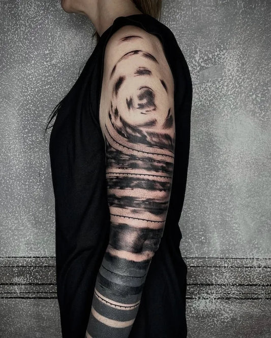 abstract blackwork brush stroke tattoo on woman full arm sleeve