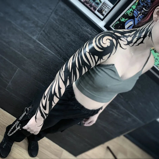 blackwork zebra pattern tattoo on woman full arm sleeve and neck