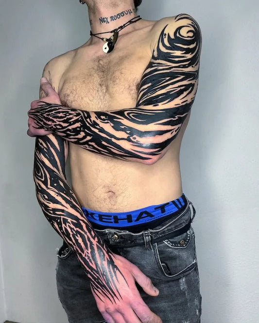 Man with black tribal tattoos on his arms