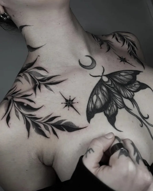 blackwork gothic moth moon leaves tattoo on woman chest