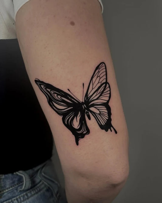 blackwork abstract butterfly on upper arm back
