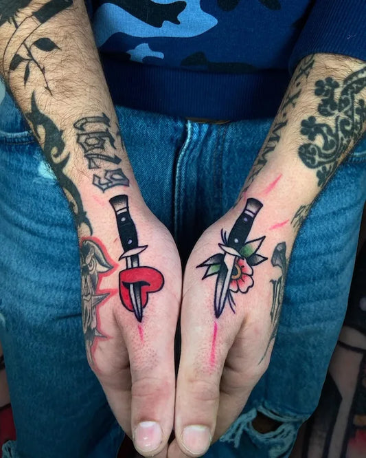matching traditional knives with heart and flower tattoo on hands