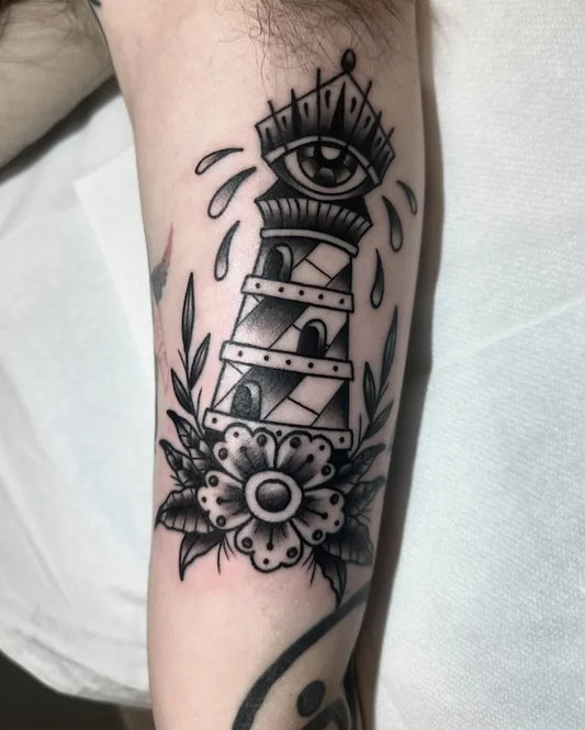 traditional lighthouse with eye and flower tattoo