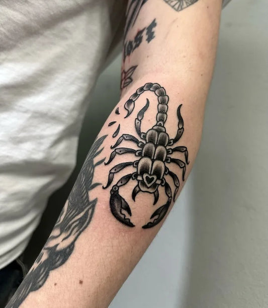 traditional black and grey scorpion tattoo on arm