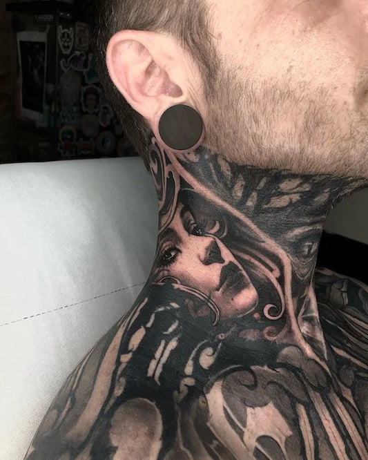 black and grey darkwork tattoo on man neck