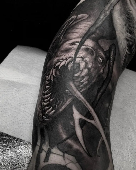 black and grey darkwork alien realism tattoo