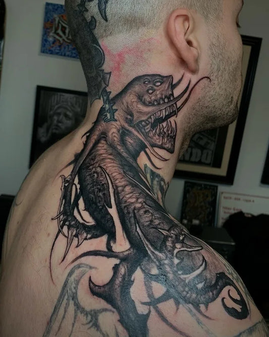 alien black and grey darkwork tattoo on man neck and shoulder