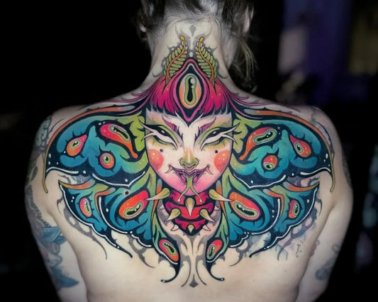 colorful new school neo-traditional creepy girl with third eye tattoo on woman back