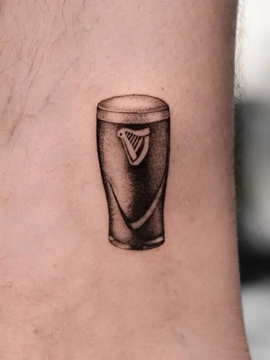 black and grey realism guinness black beer tattoo
