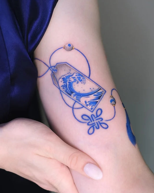 blue gold ceramic porcelain knot color realism tattoo on woman bicep