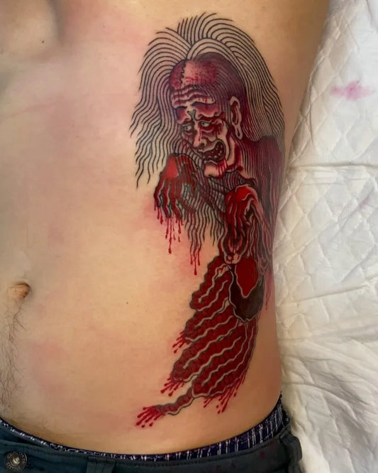thai traditional red yokai ghost krasue tattoo on man stomach