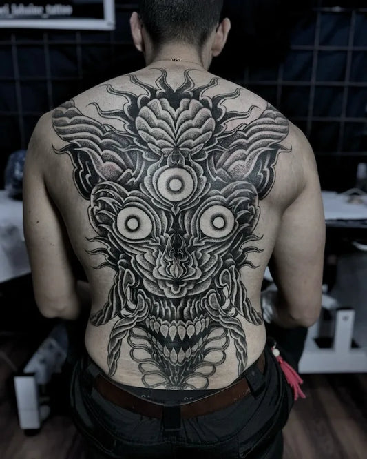 abstract 3 eyes tribal blackwork tattoo on man back full piece