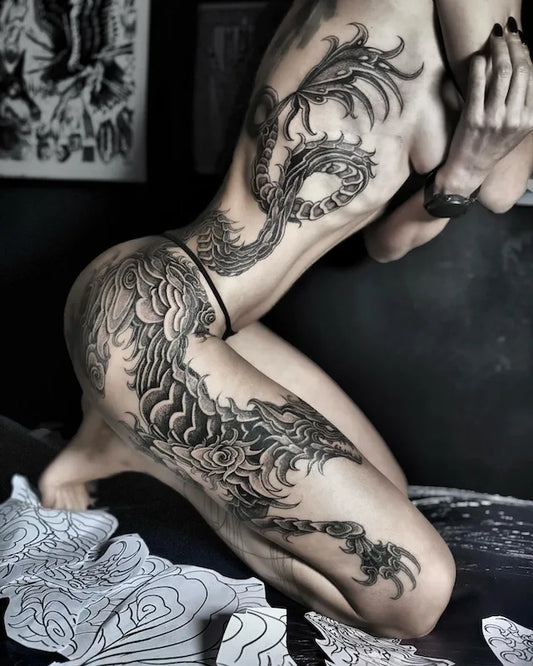 blackwork large piece tattoo on woman rib and leg