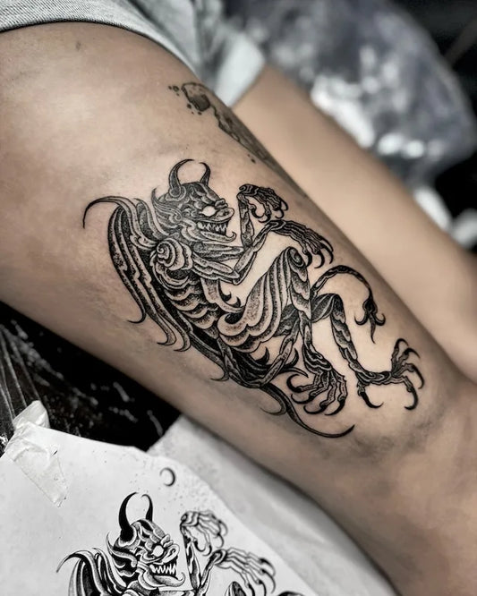 blackwork black and grey devil alien abstract tattoo on woman thigh