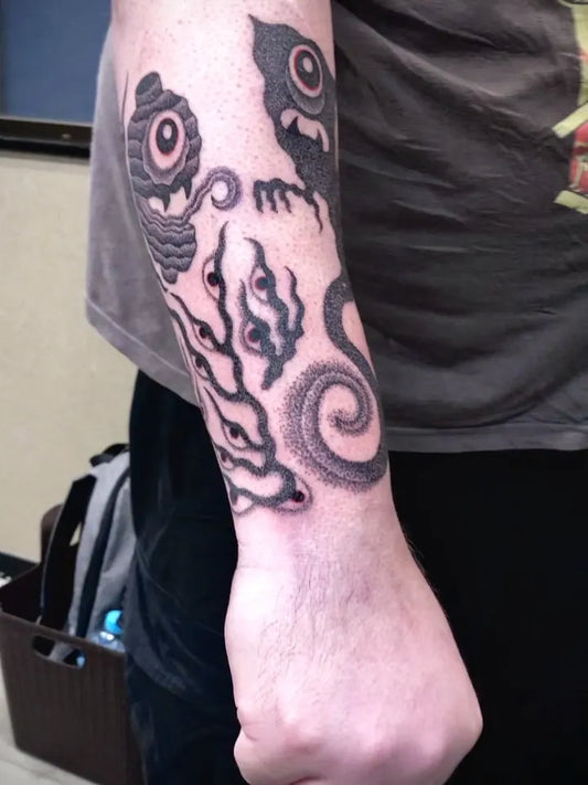 japanese one eye ghosts dotwork tattoo on man forearm