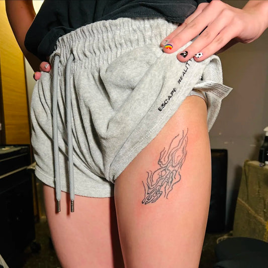 hand poke abstract thigh tattoo