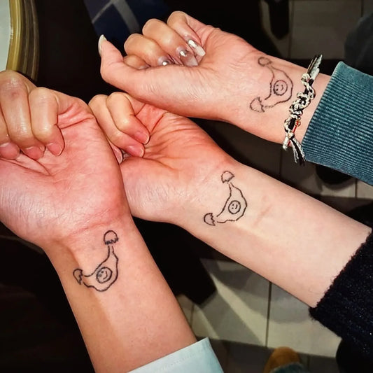 matching hand poke tattoo