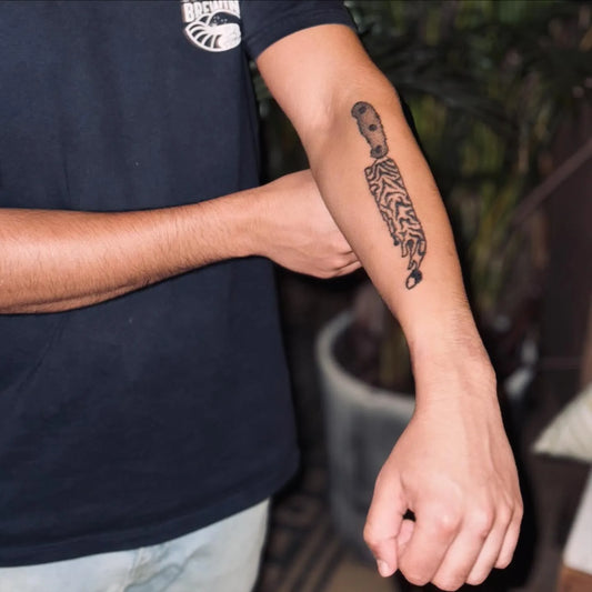 hand poke abstract knife forearm tattoo