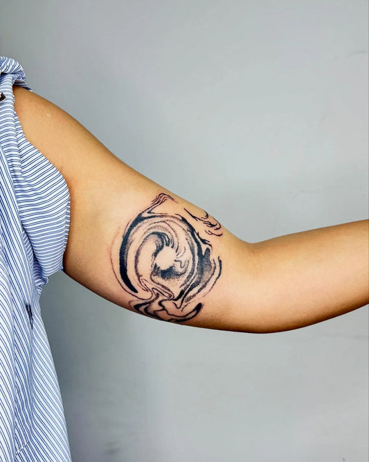 hand poke abstract bicep tattoo