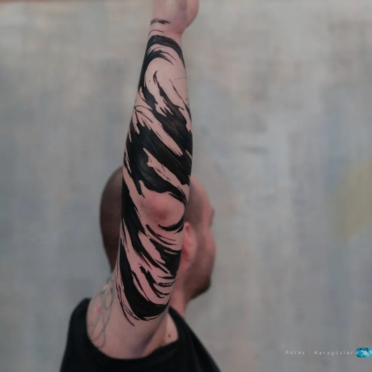 Big Abstract Splash Tattoo on Men Arm by @koray_karagozler