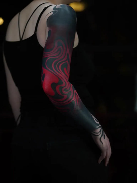Big Abstract Wavy Black and Red Lines Tattoo on Women Arm by @le.gamin.a.dix.doigts