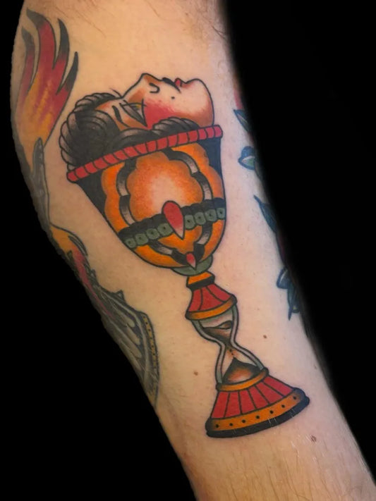 Big American Traditional Chalice with Face and Hourglass on Men Arm Tattoo by @jazzie.beau.tattoos