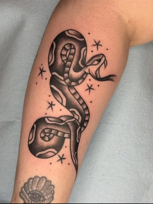 Big American Traditional Coiled Snake with Stars on Women Arm Tattoo by @blacksquirrelomaha