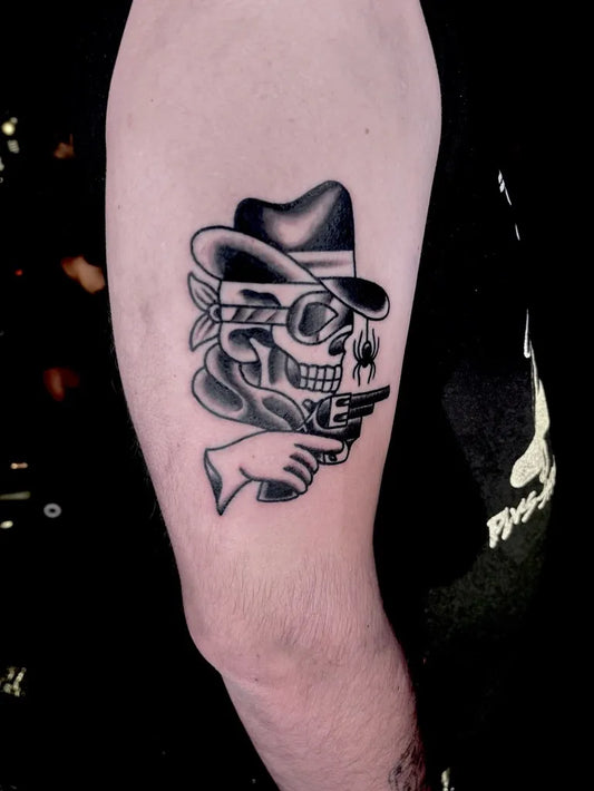Big American Traditional Cowboy Skull with Gun on Men Arm Tattoo by @tattoosbyhunterg_