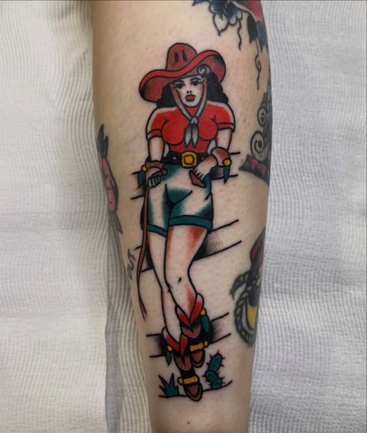 Big American Traditional Cowgirl with Cactus on Women Arm Tattoo by @lc.tattooer