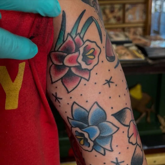Big American Traditional Daffodils and Stars on Women Arm Tattoo by @youdevilyou