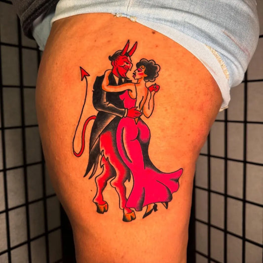 Big American Traditional Devil Dancing with Woman on Women Thigh Tattoo by @bad.bloom