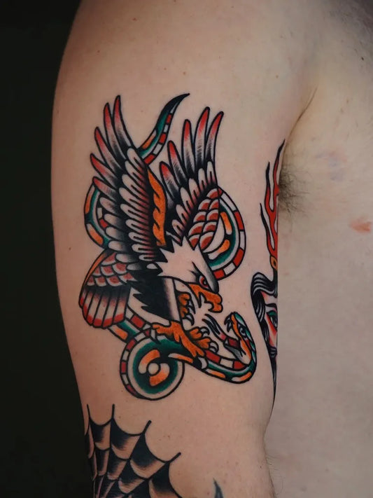 Big American Traditional Eagle Snake on Men Arm Tattoo by @figtree.tattoo.studio