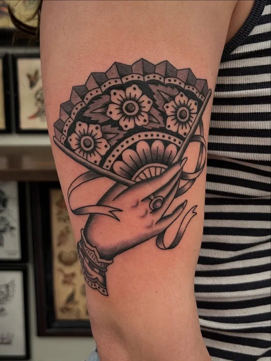 Big American Traditional Hand Holding Fan on Women Arm Tattoo by @brianvisser