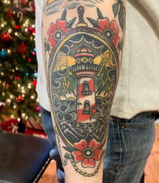 Big American Traditional Lighthouse and Flowers Nautical Tattoo on Men Arm by @adavidsontattoo